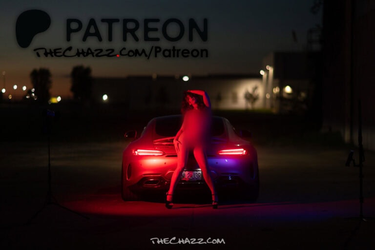Marissa poses with a silver Mercedes-AMG GTC in an industrial setting.